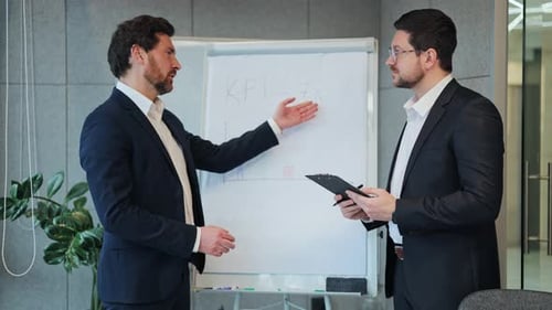 Business Professionals Discussing KPI Performance in Office Meeting