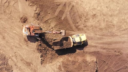 Excavator Filling Dump Truck Aerial Birds Eye View