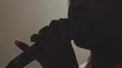 Close up of Singer Singing into Microphone