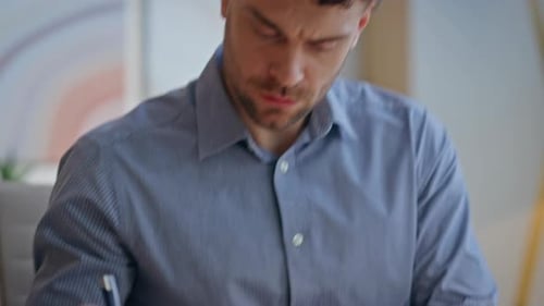 Focused Guy Working Office Sitting Modern Cabinet Closeup Man Making Notes
