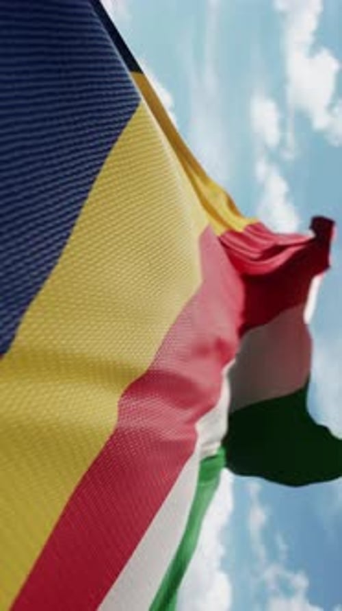 Waving Seychelles National Flag in Blue Sky