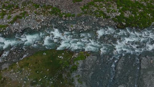 Aerial View of River With Rocks and Grass