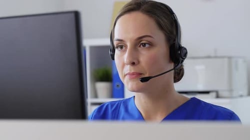 Hispanic female doctor works online at hospital helpdesk with computer technology