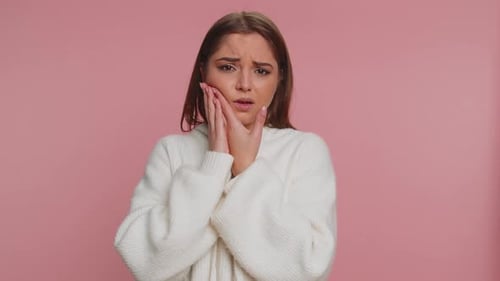Woman Touching Cheek Suffering From Toothache Cavities or Gingivitis Waiting for Dentist Appointment