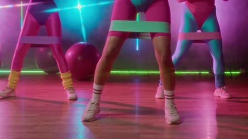 Women Exercising in 80s Style with Resistance Bands