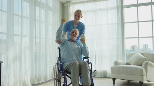 Senior Man Doing Rehabilitation Exercises with Young Nurse