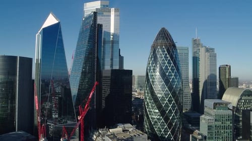 Rising aerial establishing shot of the famous skyscrapers of the London financial district in the br