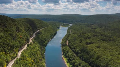 Aerial View of River Valley With Winding Road