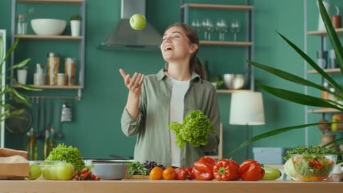 Smiling Woman Juggling Apple with Fresh Vegetables