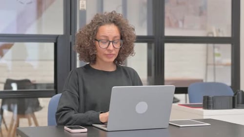 Shocked Mixed Race Woman Looking at Camera in Office