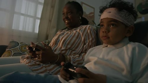 Woman and Child Play Video Games Together