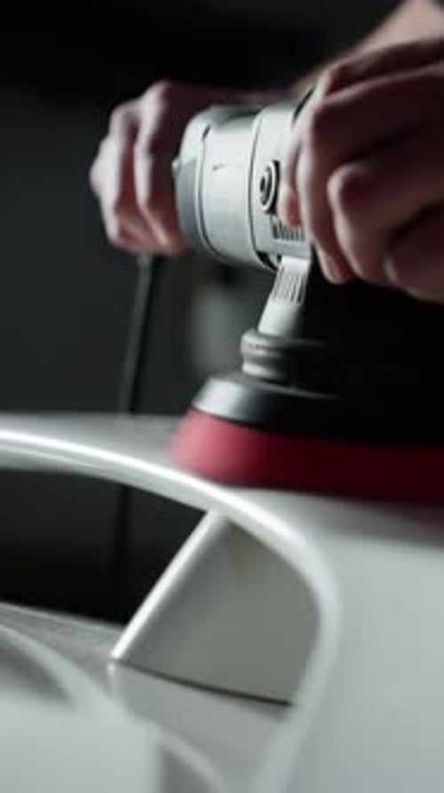 Man Polishing Car with Electric Buffer