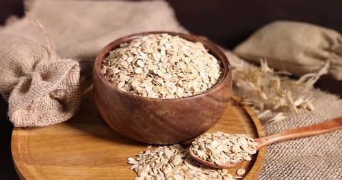 Oatmeal in Wooden Bowl with Spoon on Table