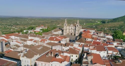 Aerial establishing shot over Portalegre cityscape and Cathedral on sunny day, Alentejo