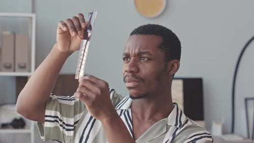 Young Adult Examining Film Negatives