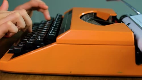 Writing letters with orange retro vintage typewriter