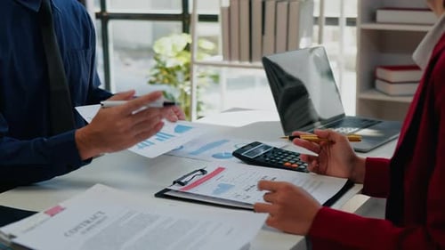 Professionals Reviewing Financial Documents in Office