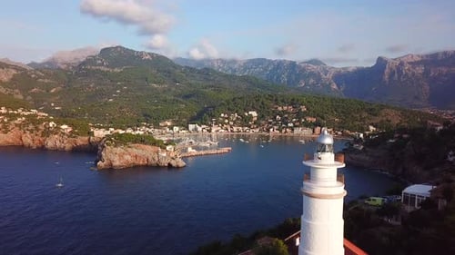 Drone view of a white lighthouse in Port de Soller, Mallorca, Spain