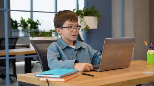 Boy Studies with Laptop at Modern Desk