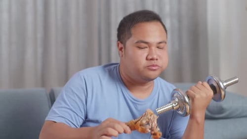 Man Lifts Weights While Eating Fried Chicken