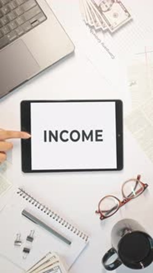 VERTICAL VIDEO OF INCOME DISPLAYING ON A TABLET SCREEN