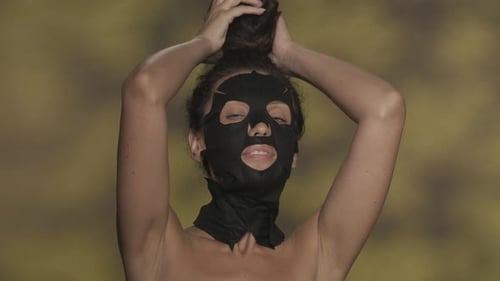 Woman Applies and Removes Black Facial Sheet Mask