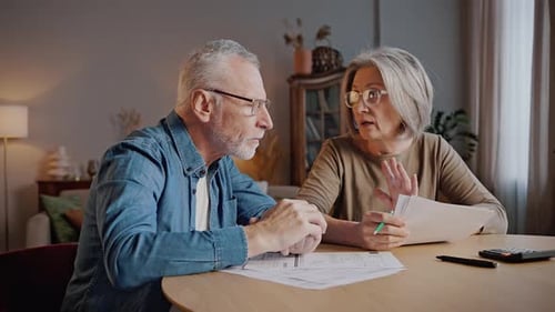 Senior Couple Reviewing Finances at Home Indoors
