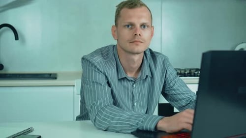 Serious Man Using Laptop Texting Communication at Home Office Studio