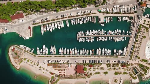 Sailing Vessels Await Adventure in harbour. A bird's-eye view showcases a marina brimming with boats