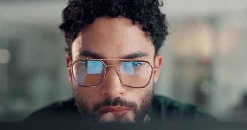 Close Up Of Man Wearing Glasses Looking At Screen