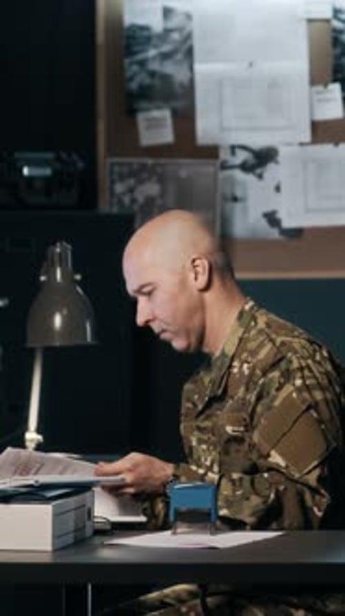 Tired Commander Working with Documents in Military Hub
