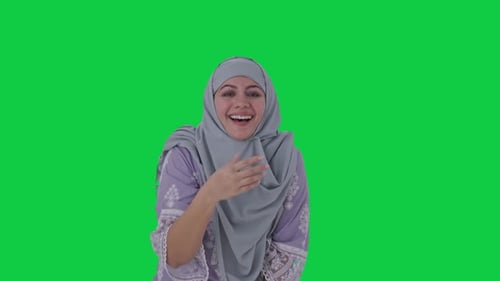 Happy Muslim woman laughing on someone Green screen