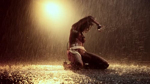 Solo Woman Dancing Sensually in the Heavy Rain