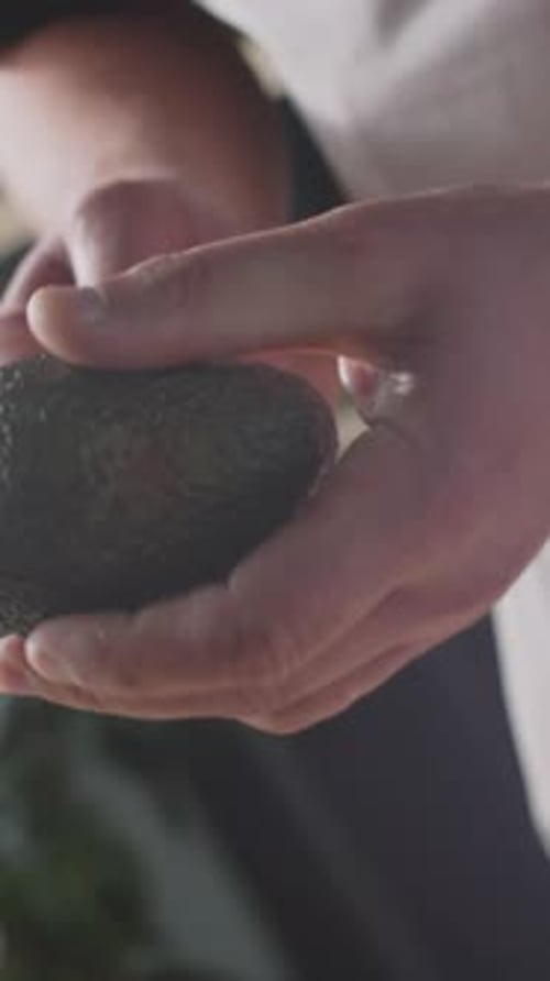 Cutting a Fresh Avocado in Half with Knife