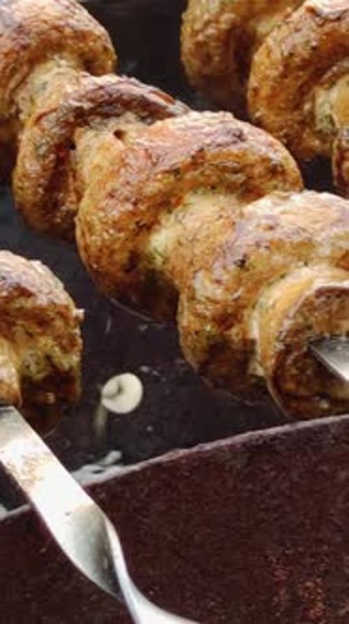 Mushrooms on Skewers Cooking on a Barbecue Grill