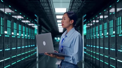 Asia Female Professional Worker Use Laptop And Look Around In Data Center