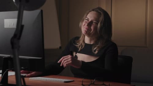 Woman Typing on Computer at Desk in Office