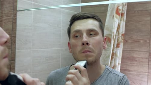 Man Shaving With Electric Razor