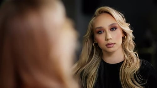 Model's Reflection in Makeup Studio