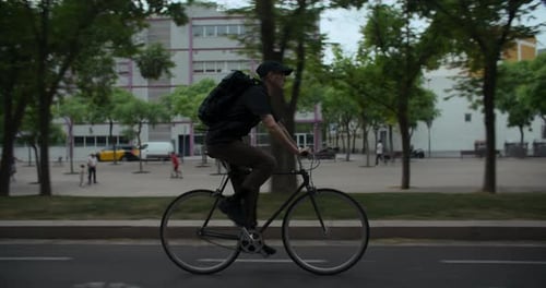 Young Man Rides Commuter Bicycle in the City