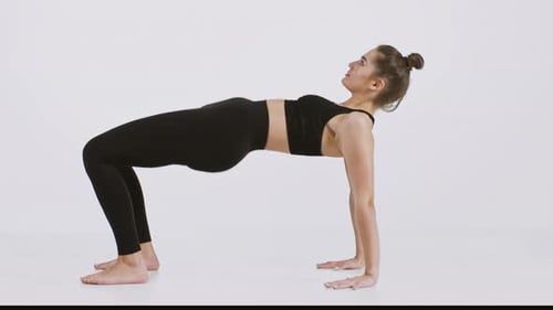 Stretching Exercises By a Woman Practicing Yoga for a Healthy Lifestyle