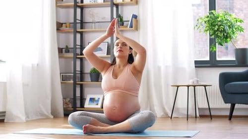 Pregnant Woman Doing Yoga in Bright Home