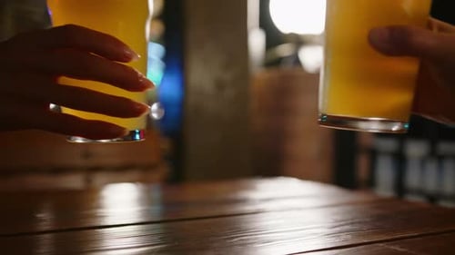 People are clinking glasses of beer