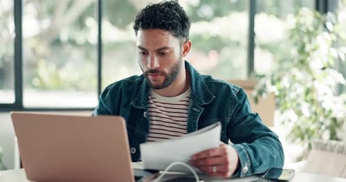 Laptop, research and man in office with documents, business ideas or planning for project