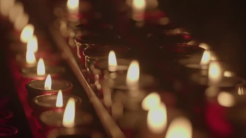 Illuminated Votive Candles Flicker in Soft Light
