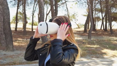 Woman Uses VR Headset in Sunny Beach Forest