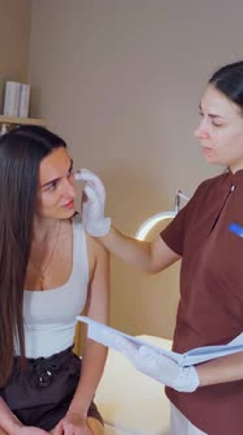 Young Woman Consulting with Doctor in Office