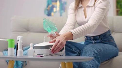 Close-up woman's hand power on inhaler