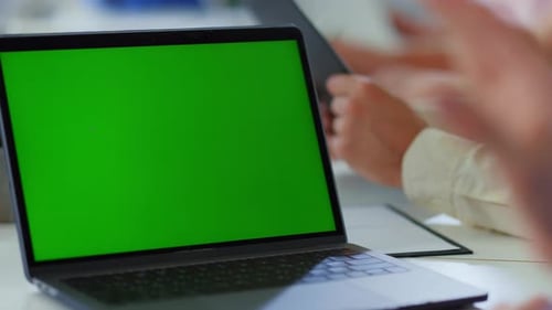 Unrecognizable business people working with green screen digital devices in office