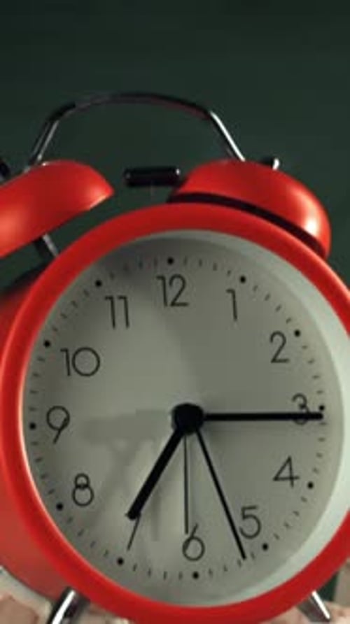 Alarm Clock Flies with School Chalk Against the Background of the Blackboard Filmed on a Highspeed